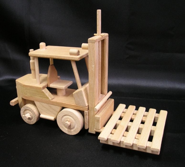 Forklift with wooden pallet. Moving wooden toys